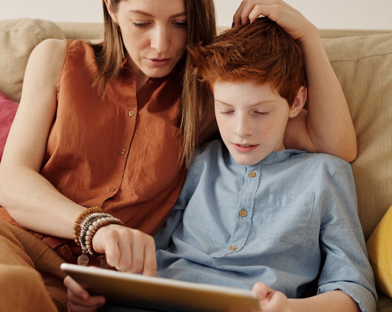 a mother and her child using a tablet