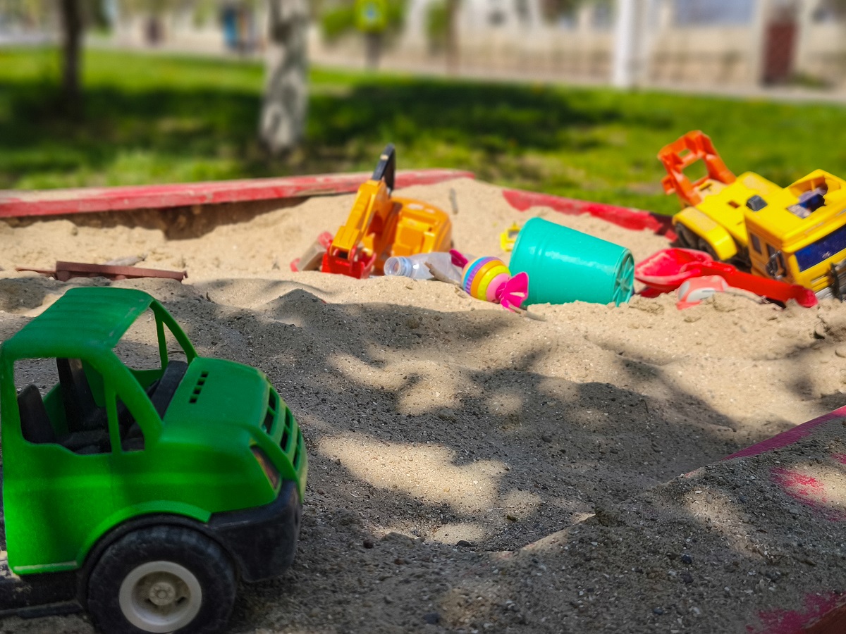 sandbox with toys in a backyard play area