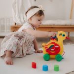a toddler playing with her toys