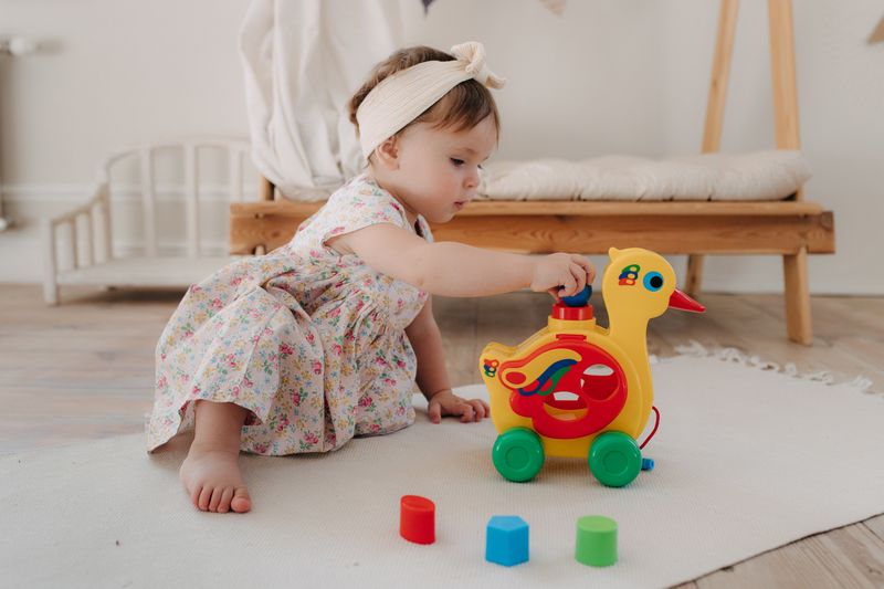 a toddler playing with her toys